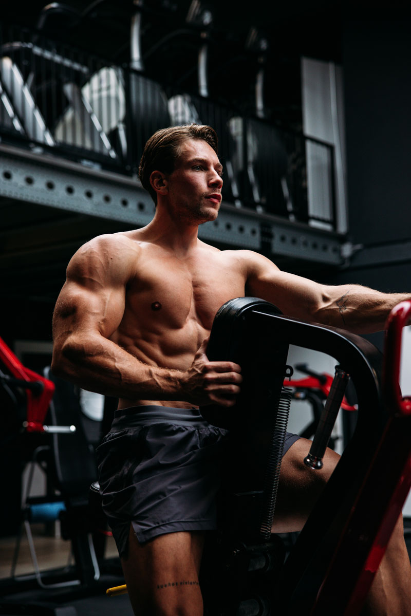 The coach is exercising in the gym.